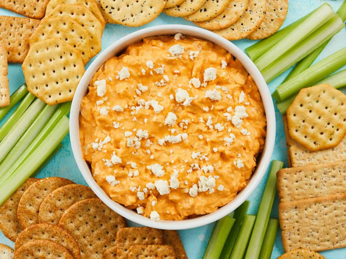 Overhead view of a the buffalo chicken dip surrounded by crackers and vegetables.