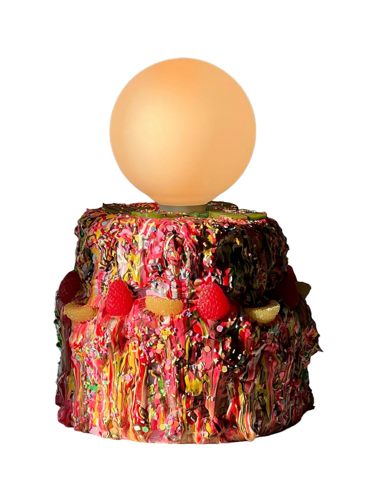 A lamp with a base that looks like a messy cake